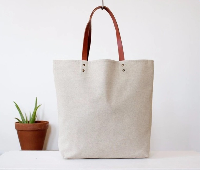 Natural white cotton fabric tote bag with leather strap